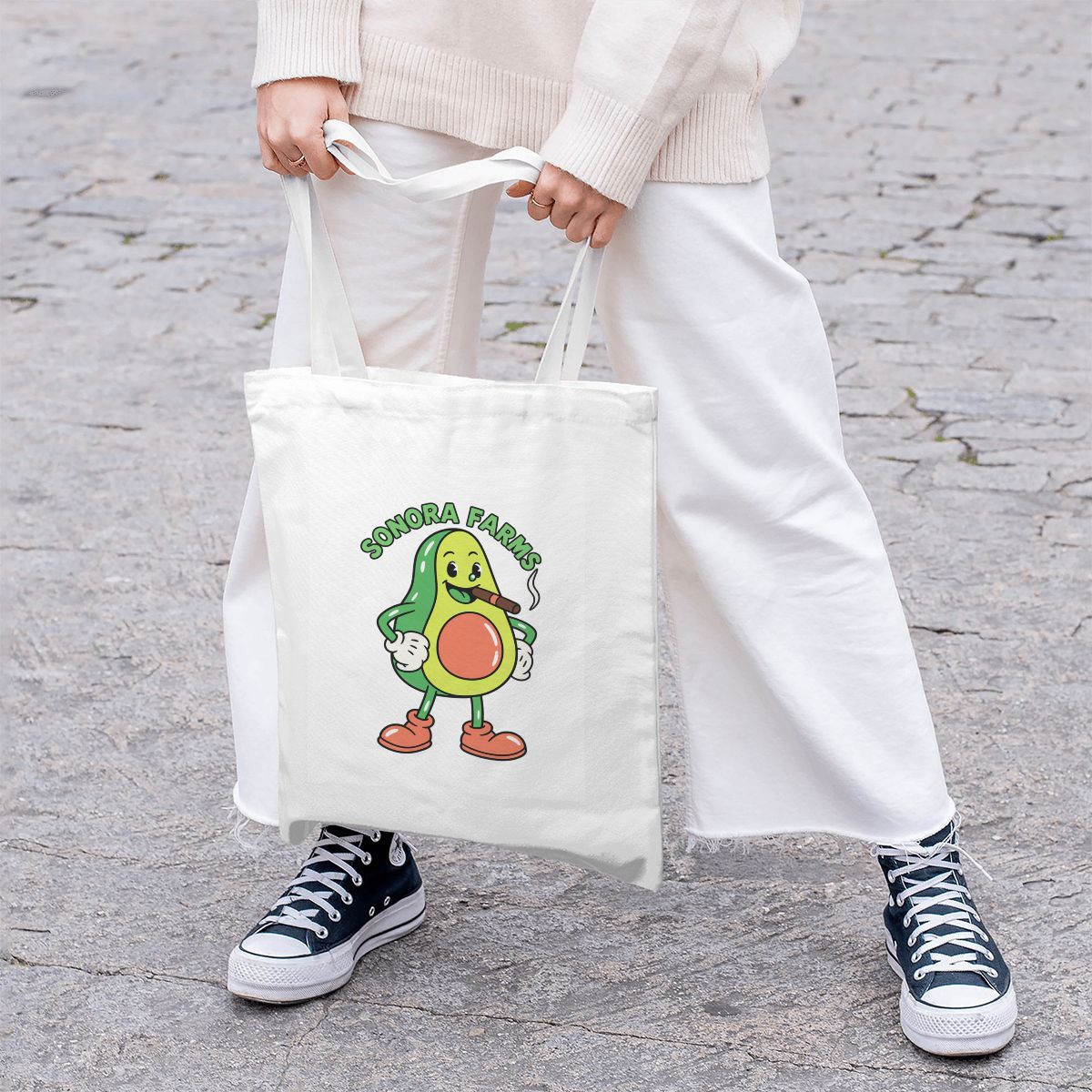Lifestyle mockup of a person carrying the custom logo white canvas tote bag.