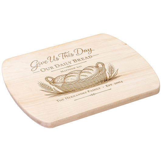 Angled view of a personalized maple oval board engraved with Give Us This Day Our Daily Bread, Matthew 6:11, bread and wheat.